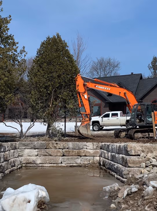 Excavator digging a narrow utility trench Bobcaygeon