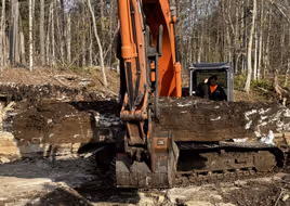 Excavator working in dirt